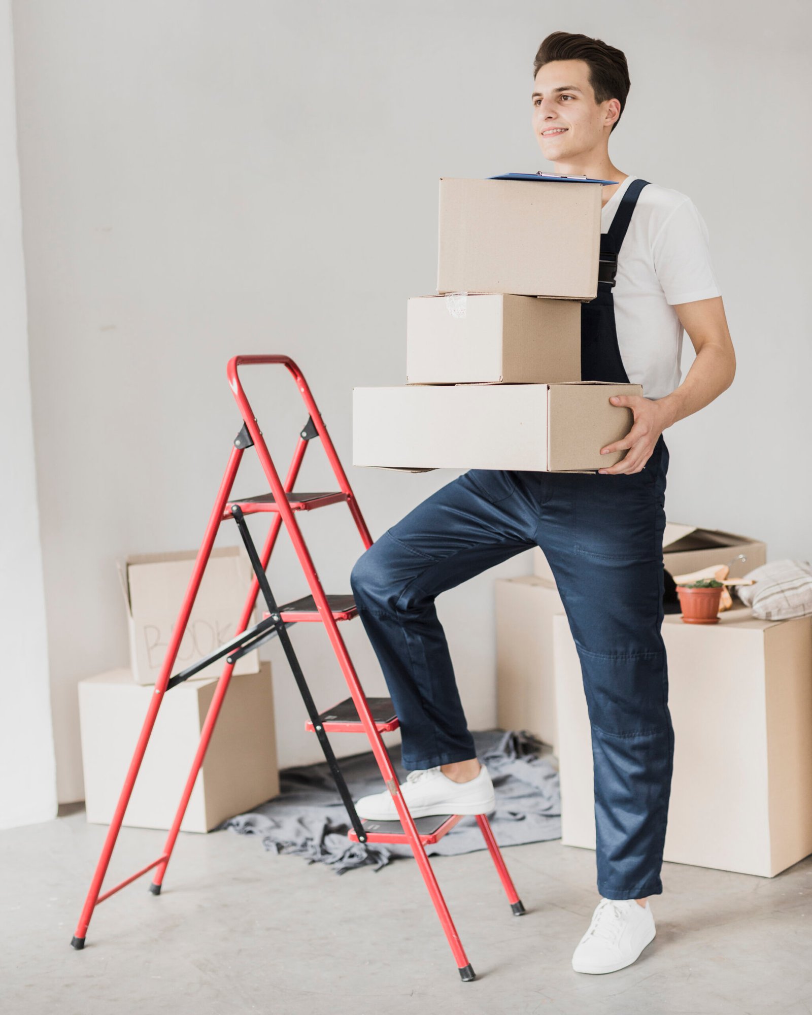 young-man-holding-boxes-with-foot-ladder
